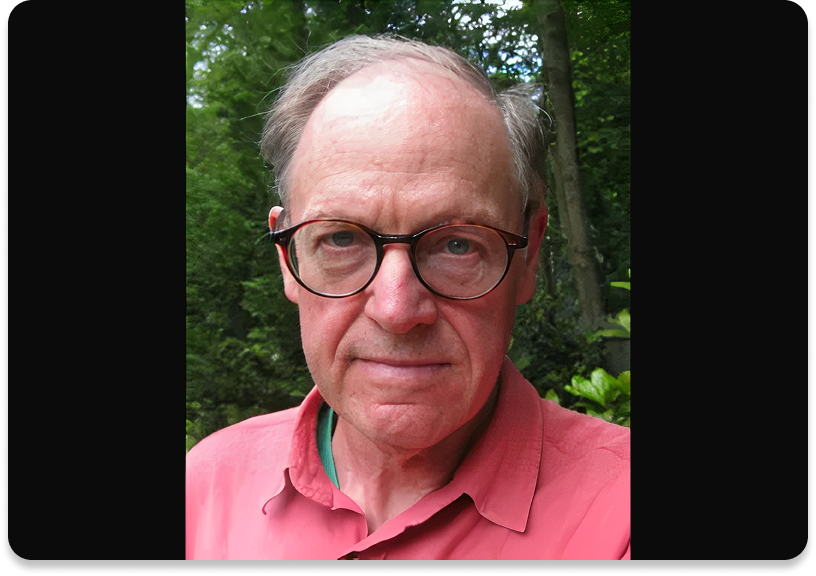 Man wearing glasses, outdoors in garden.